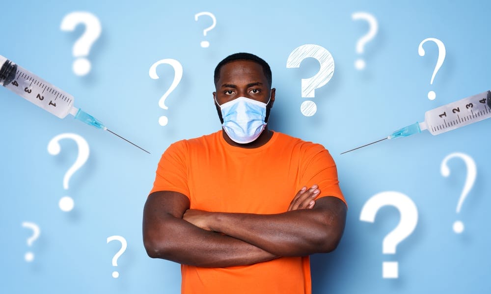 Man with face mask has a lot of questions and doubts about covid 19 vaccine
